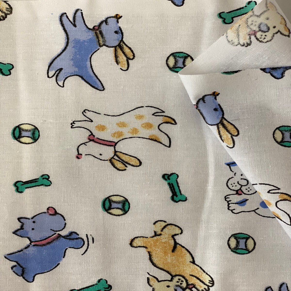 White | Blue Puppy Bone Print Poly Cotton Fabric - Fashion Fabrics LLC