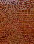 Tela de vinilo de cocodrilo marrón coñac 